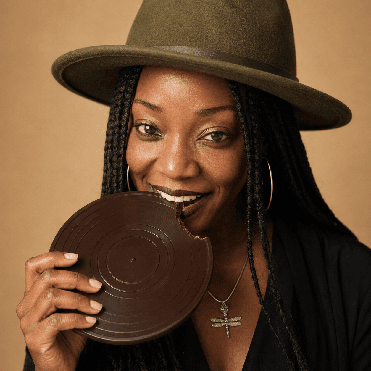 DJ Mz Chocolate holding a chocolate vinyl record